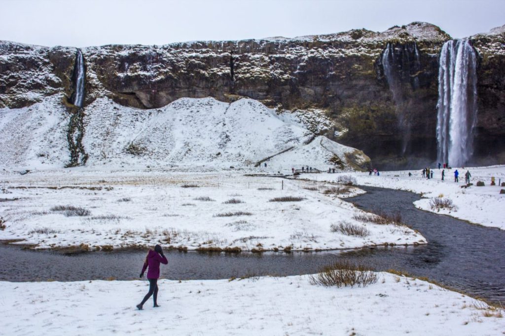 Seljalandsfoss in front of walking waterfall Iceland Solo Female Travel Roadtrip Winter